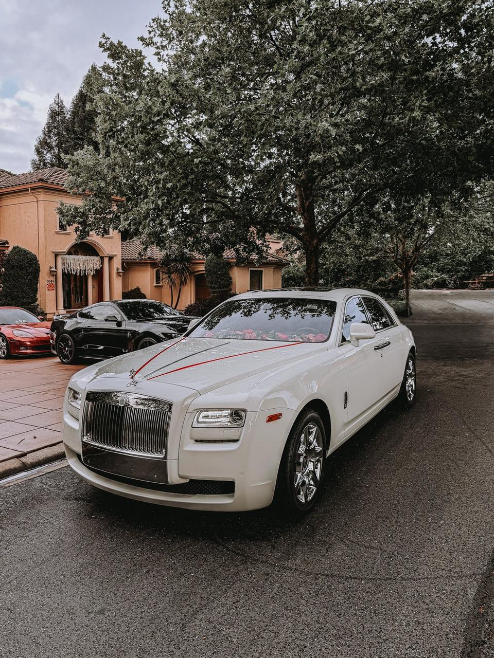 White 2015 Rolls-Royce Ghost luxury sedan, front view